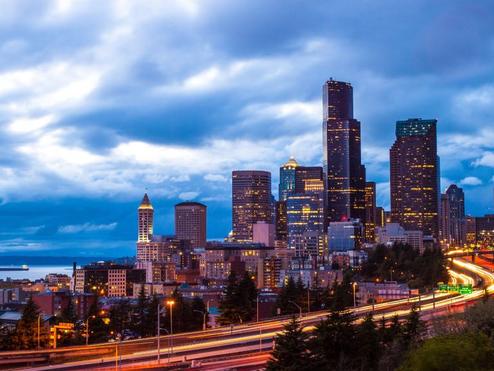 An image of downtown Seattle, lit up at night.