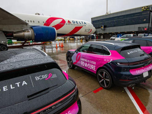 BCRF plane awaits takeoff amidst BCRF branded Porsches on September 26, 2024.