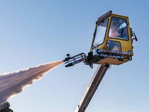 Tip of airplane wing being deiced