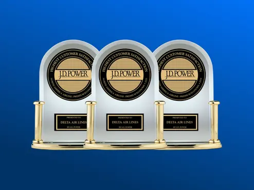 Three J.D. Power trophies against a blue background