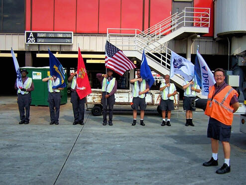 Honor Guard members standing in line with flags