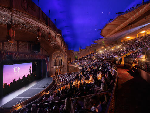 Interior view of the Fox Theatre, with guests seated and watching the film during the premiere event.