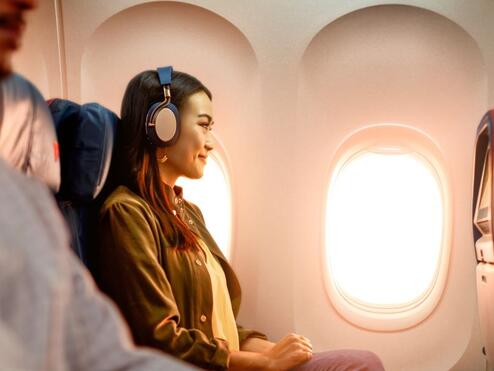 A woman enjoys In-Flight Entertainment onboard a Delta flight.