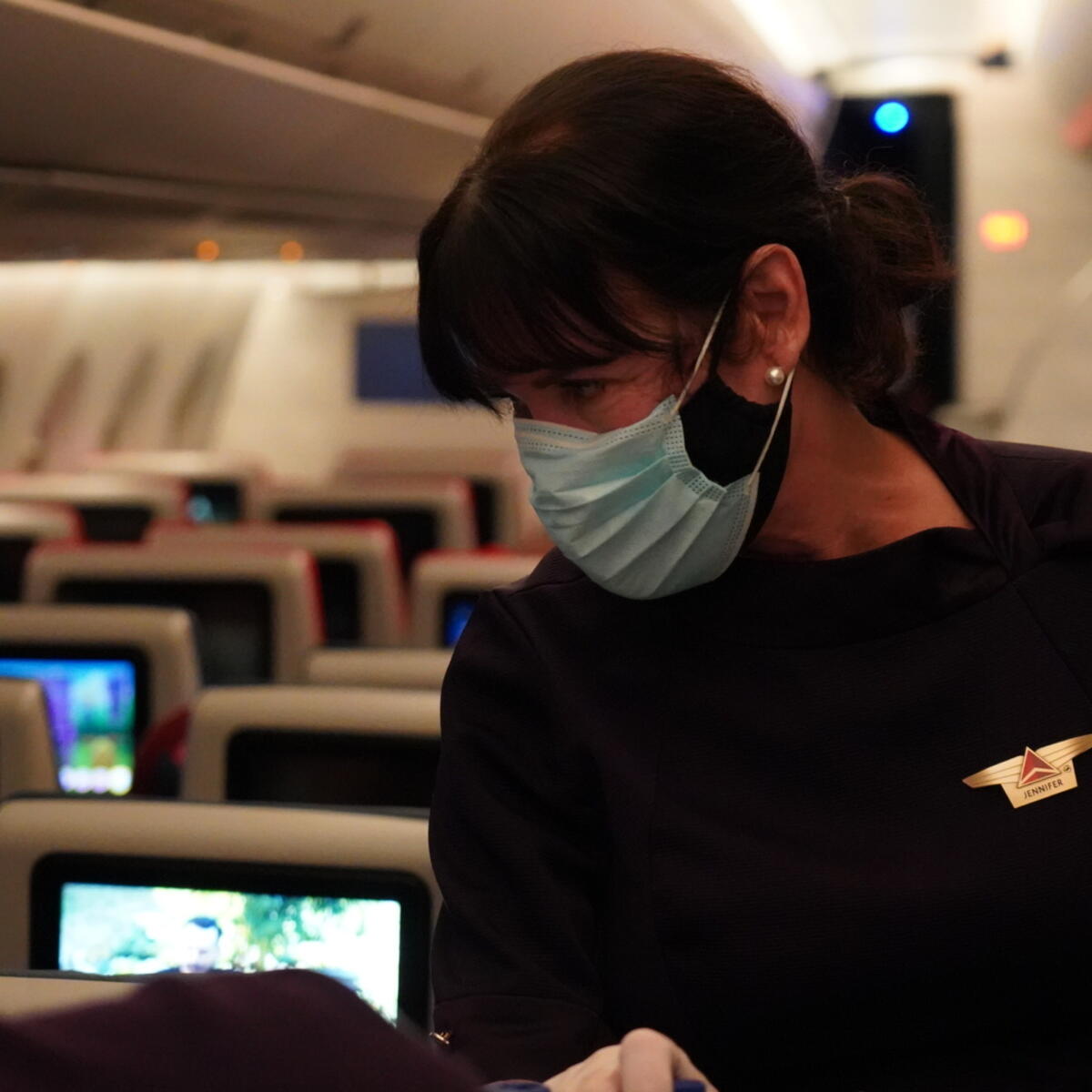 Delta Air Lines Flight Attendant serves passengers during CRAF mission.
