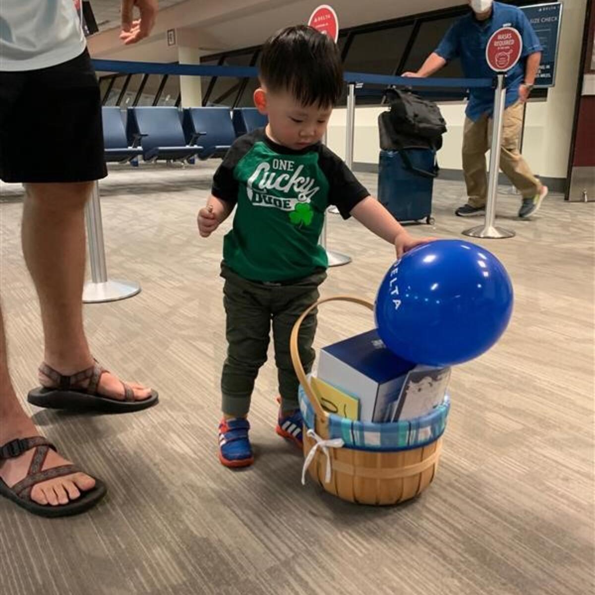 Beau checks out the balloons given to him by the Delta staff.