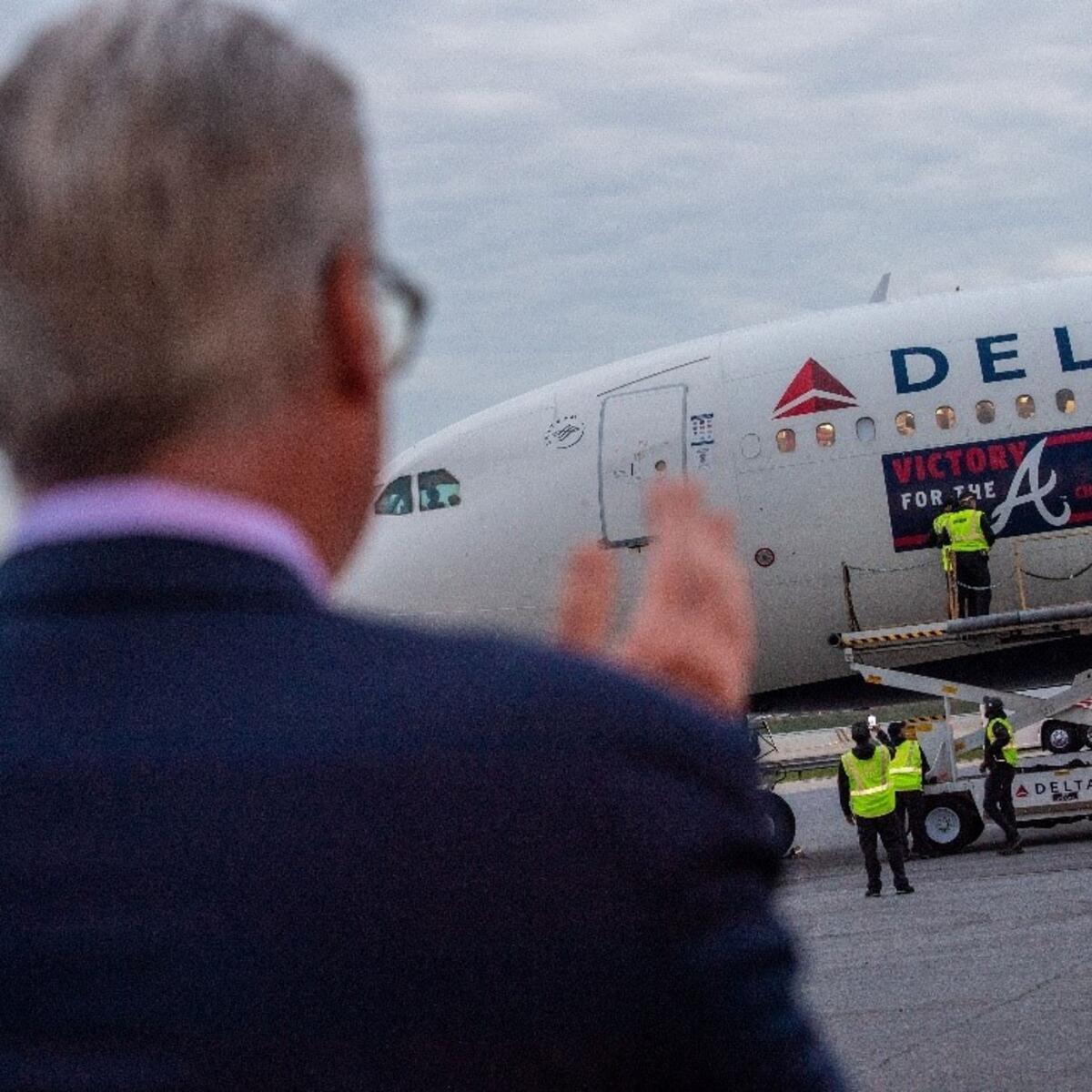 Ed Bastian looks on as the Braves' plane arrives.