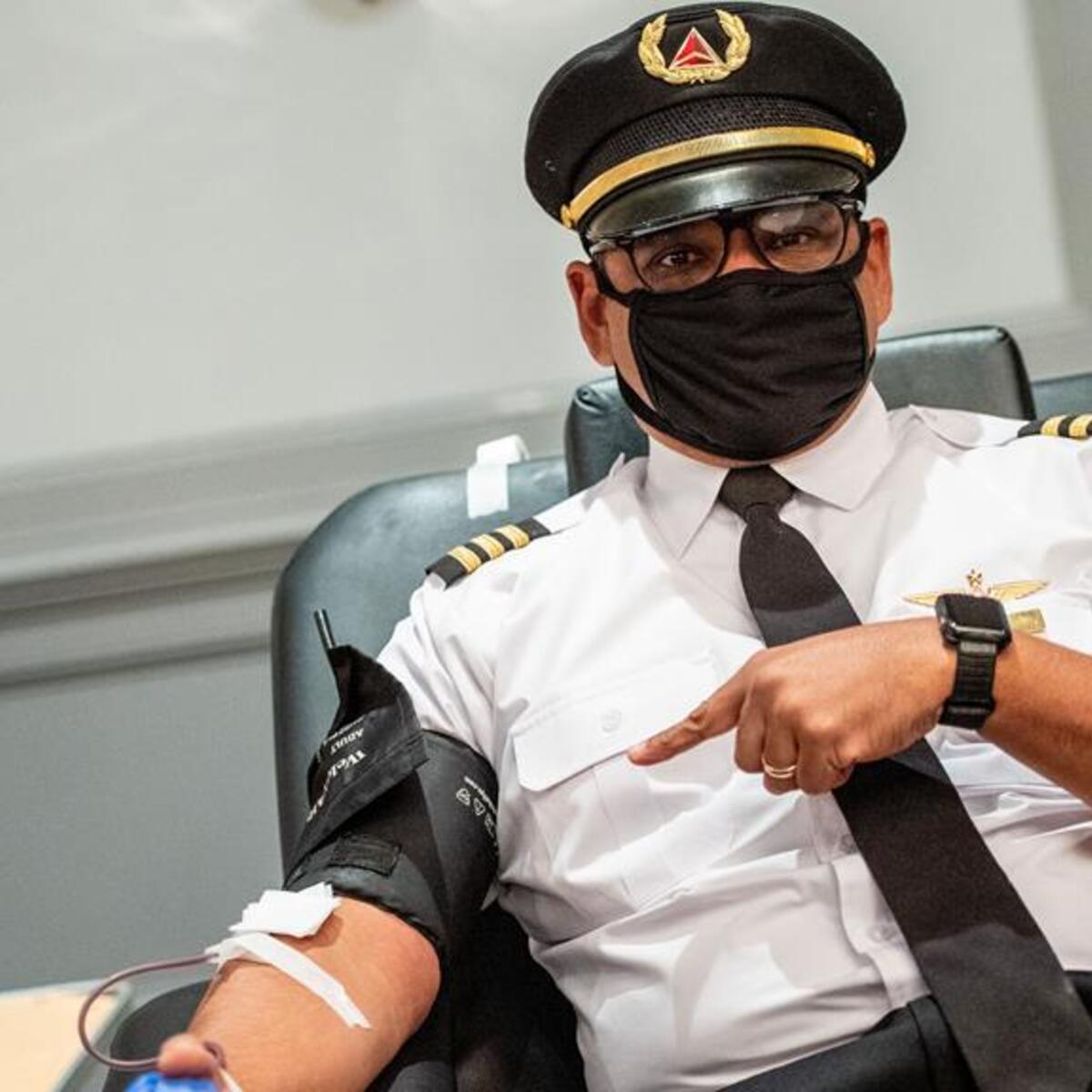 Captain Joe Pinkelton with mask giving blood