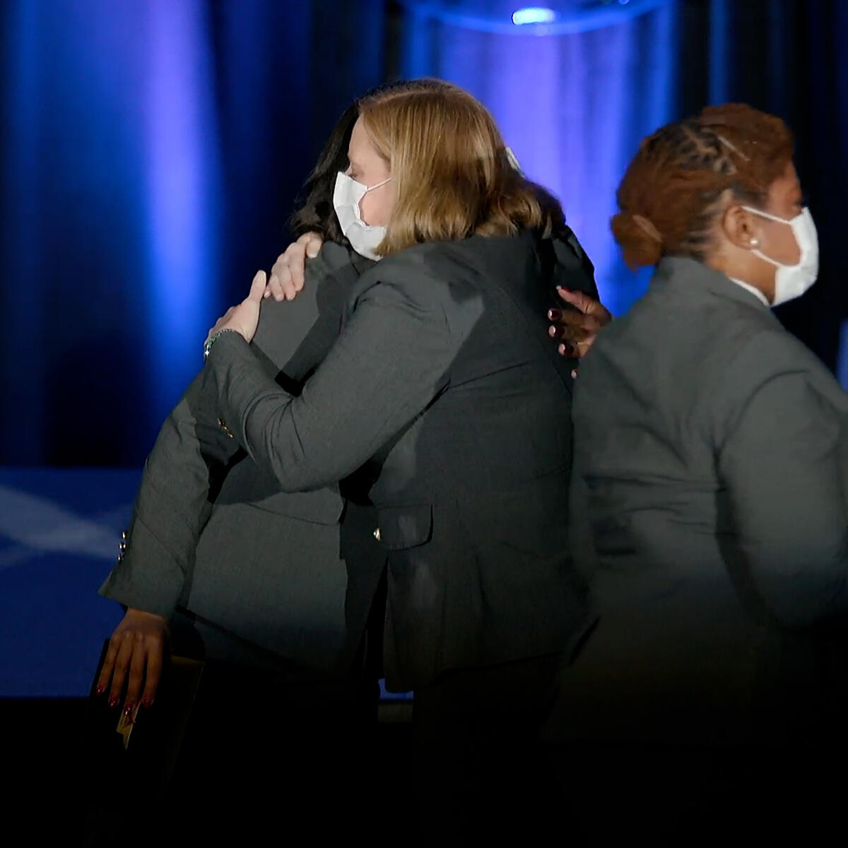 Flight attendants exchange hugs after graduation