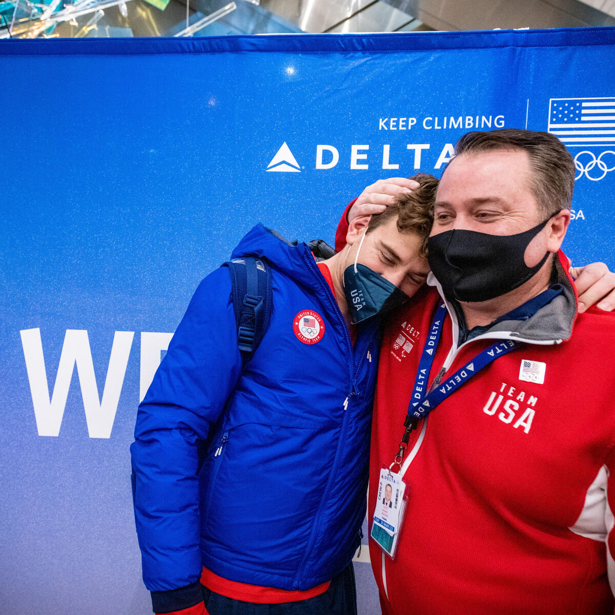 Brandon Frazier (left) and his uncle, Delta Air Lines First Officer Scott Frazier, share a moment as Team USA athletes arrive at Salt Lake City International Airport in Salt Lake City, Utah on Monday, February 21, 2022.