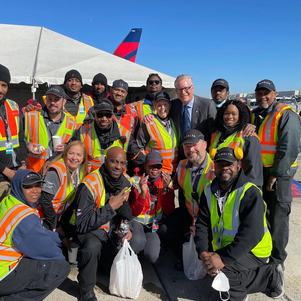 Delta CEO Ed Bastian poses with ramp crew members in Atlanta for Employee Appreciation Day.