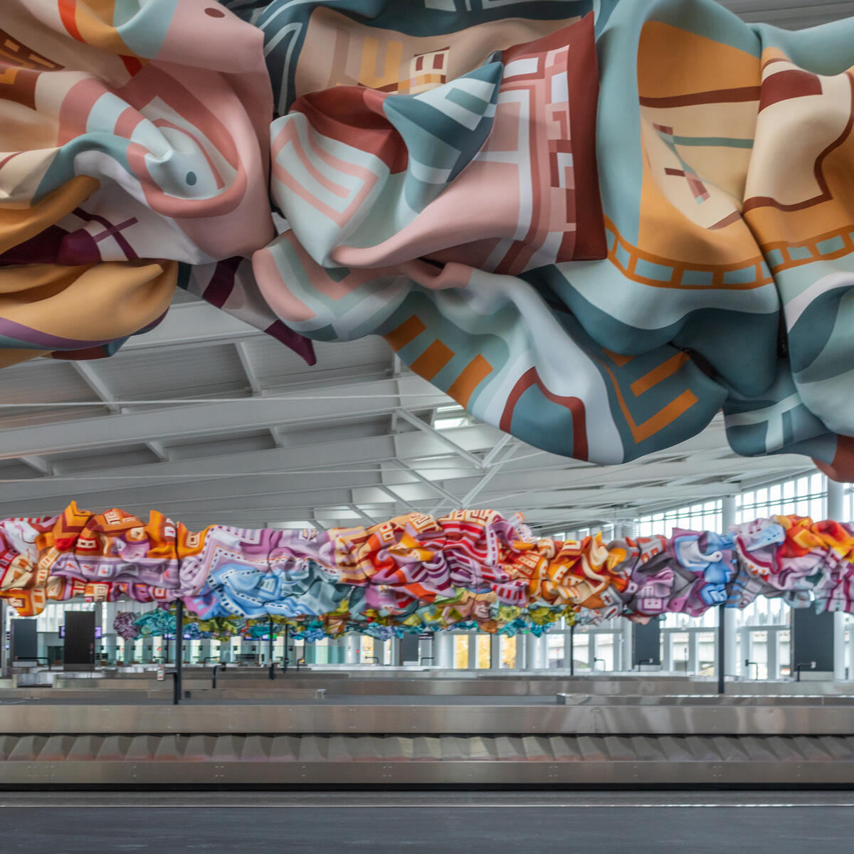 Baggage claim at International Arrivals Facility, featuring work by local Seattle artist Marela Zacarias