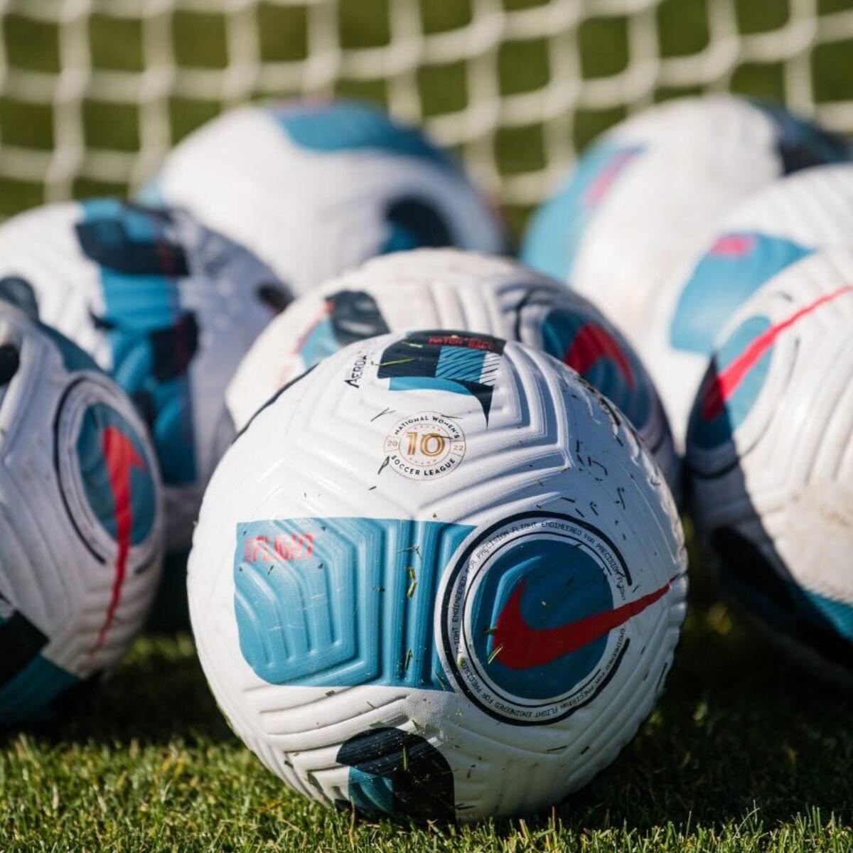 Arrary of soccer balls announcing partnership with National Women’s Soccer League 