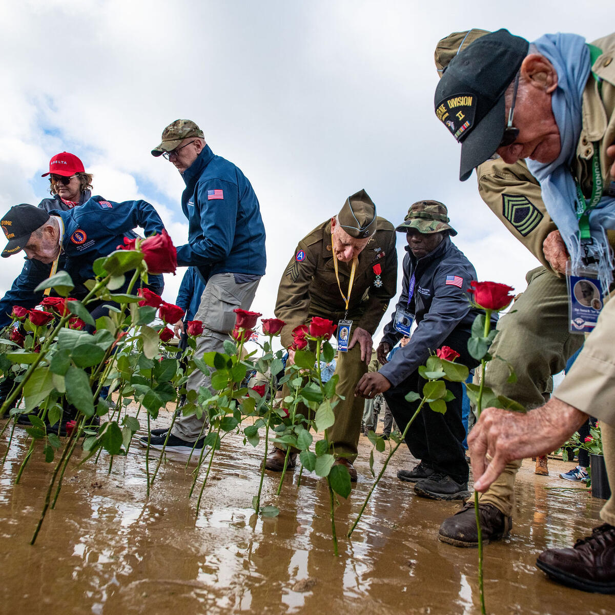 Delta veterans assist the World War II veterans in the rose-laying ceremony on Utah Beach.