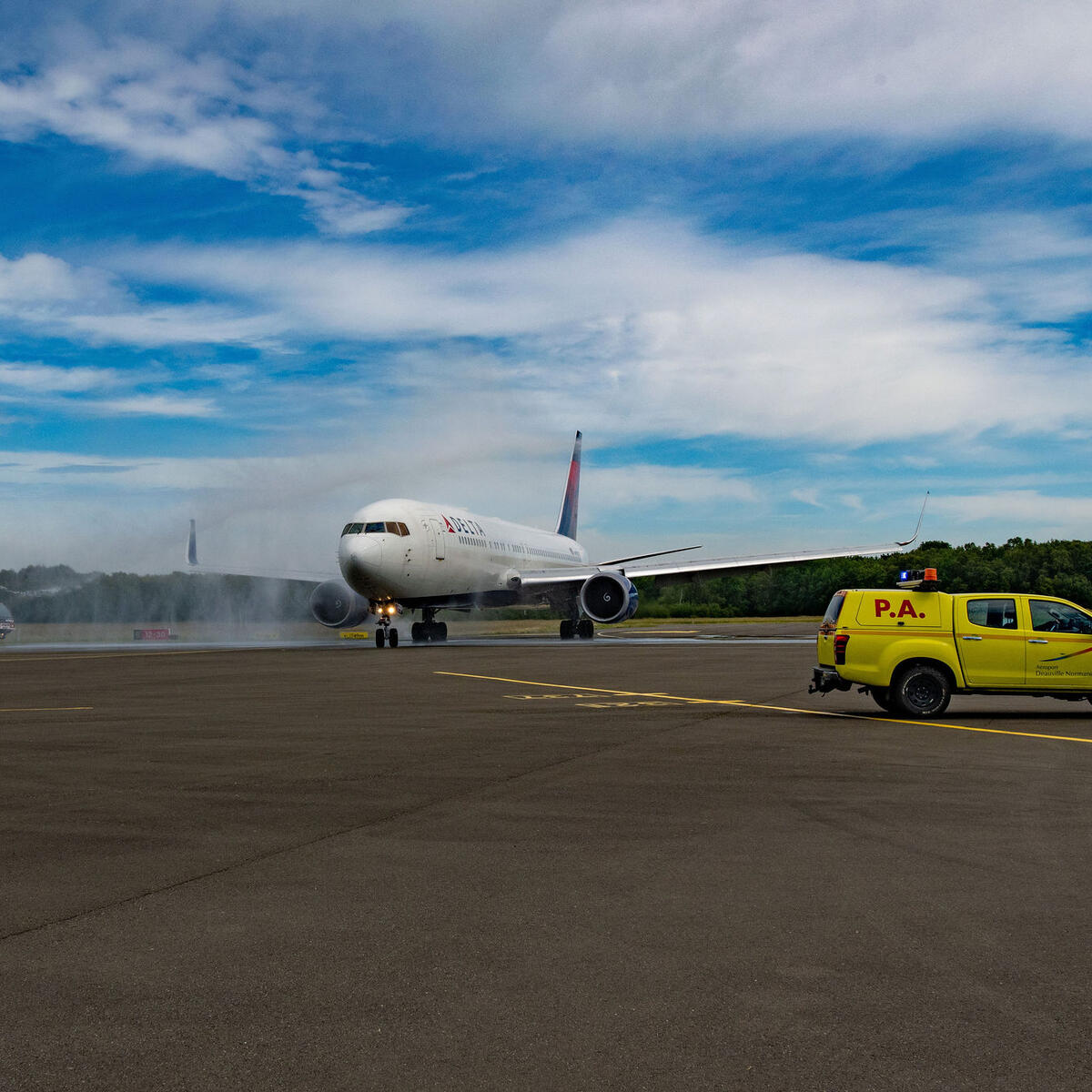 Delta makes its historic landing at DOL and is welcomed with a water cannon salute.