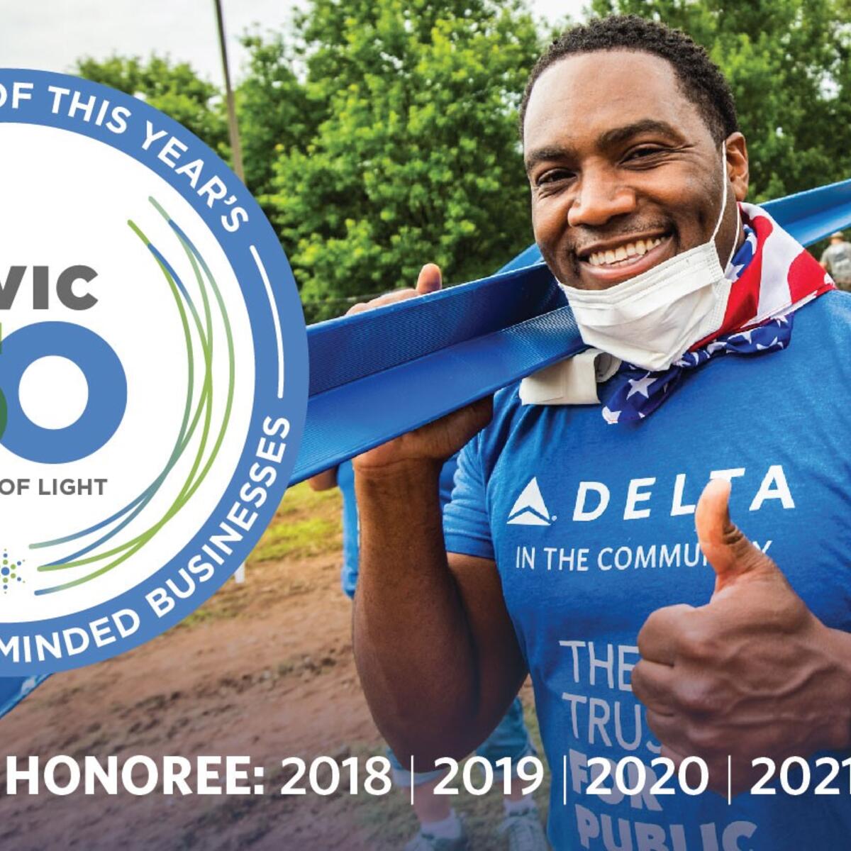 Photo featuring Delta volunteer with badge for winning Points of Light for fifth year in a row.