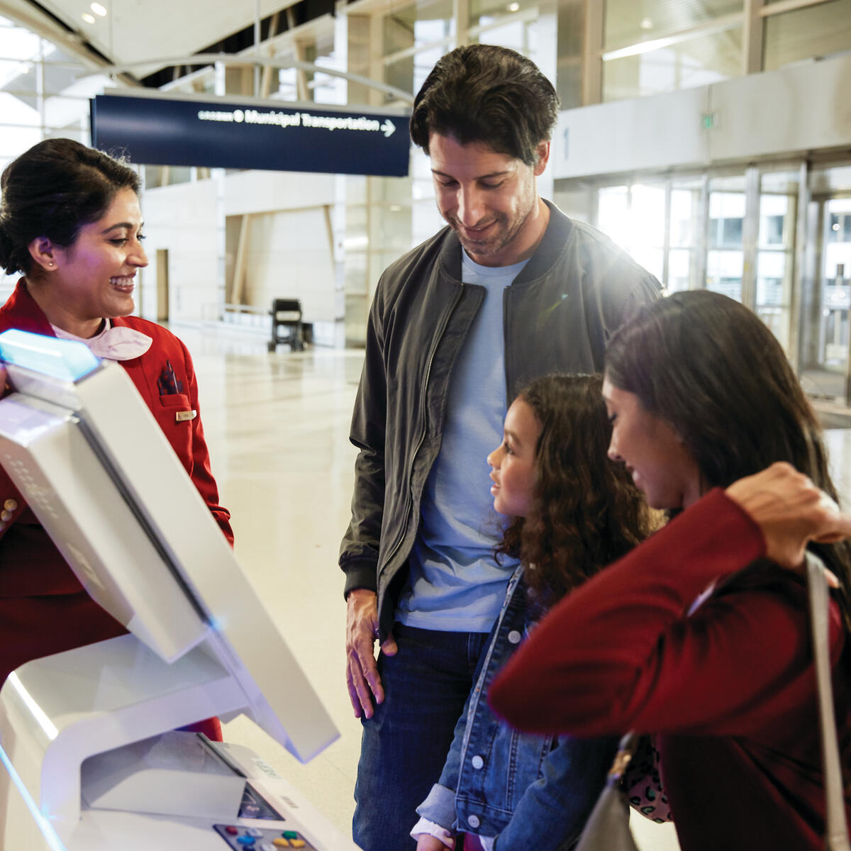 A family checks in with the help of a famous Delta Red Coat.