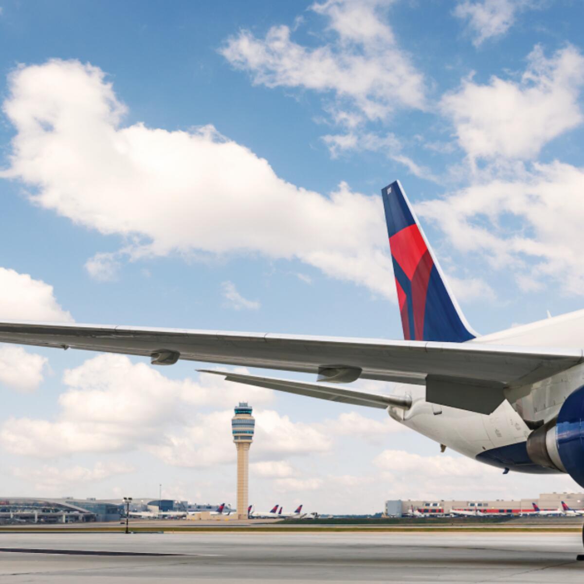 A dorsal view of Delta's Boeing 767-400 model sits on the Atlanta-based runway while a dynamic sky overlooks. 