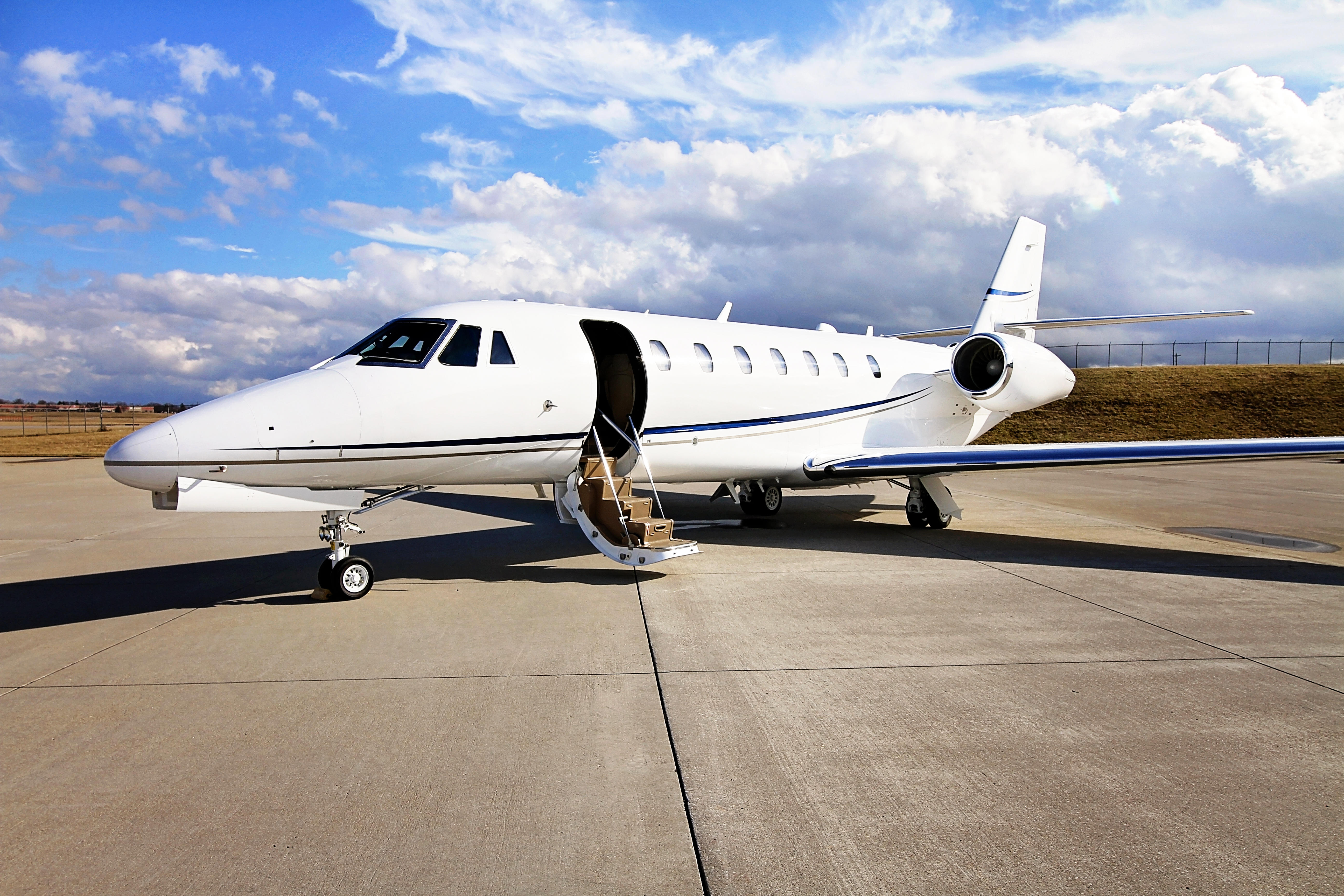 Delta Private Jet Citation Sovereign on Runway while a clouded background overlooks the scene.