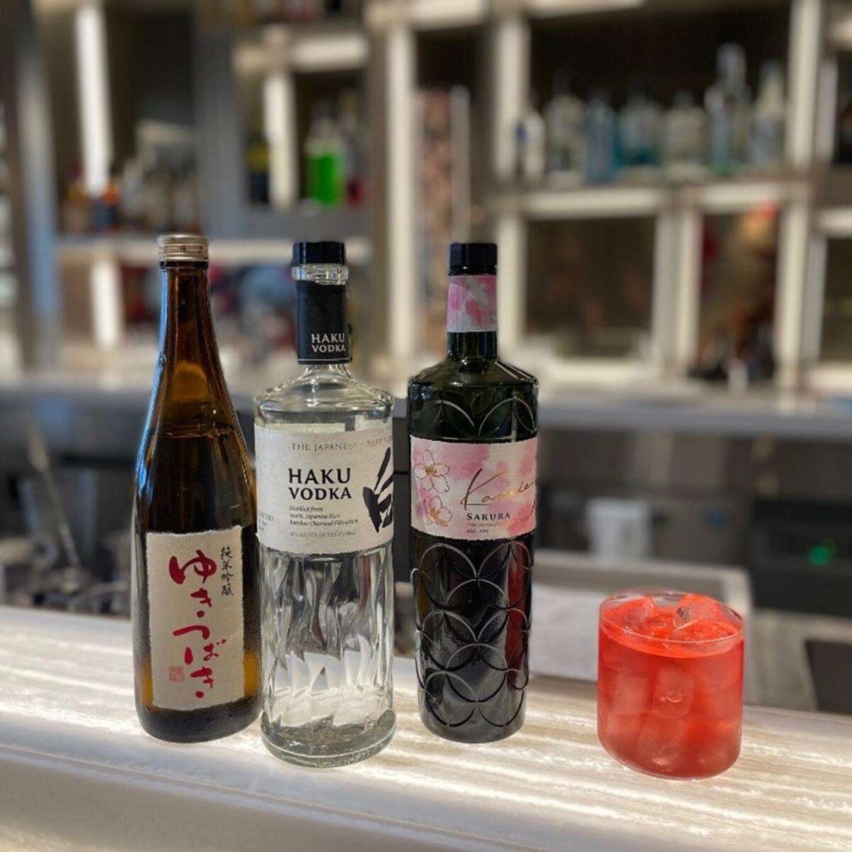 A Sake Blossom Cosmo (right), a cocktail created exclusively for Haneda’s Delta Sky Club.