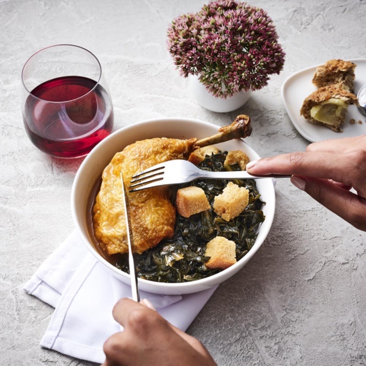 Roasted chicken with smoked collard greens, a Delta first class meal offering, created by Chef Mashama Bailey