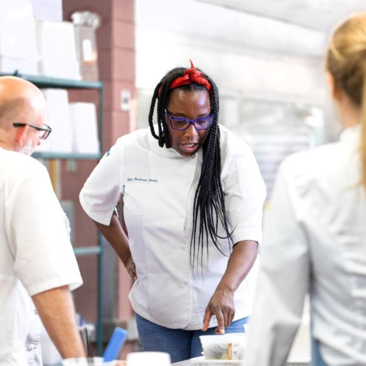 Chef Masama Bailey, whose signature Southern flair is now featured on Delta flights departing Atlanta, works with her team in the kitchen.