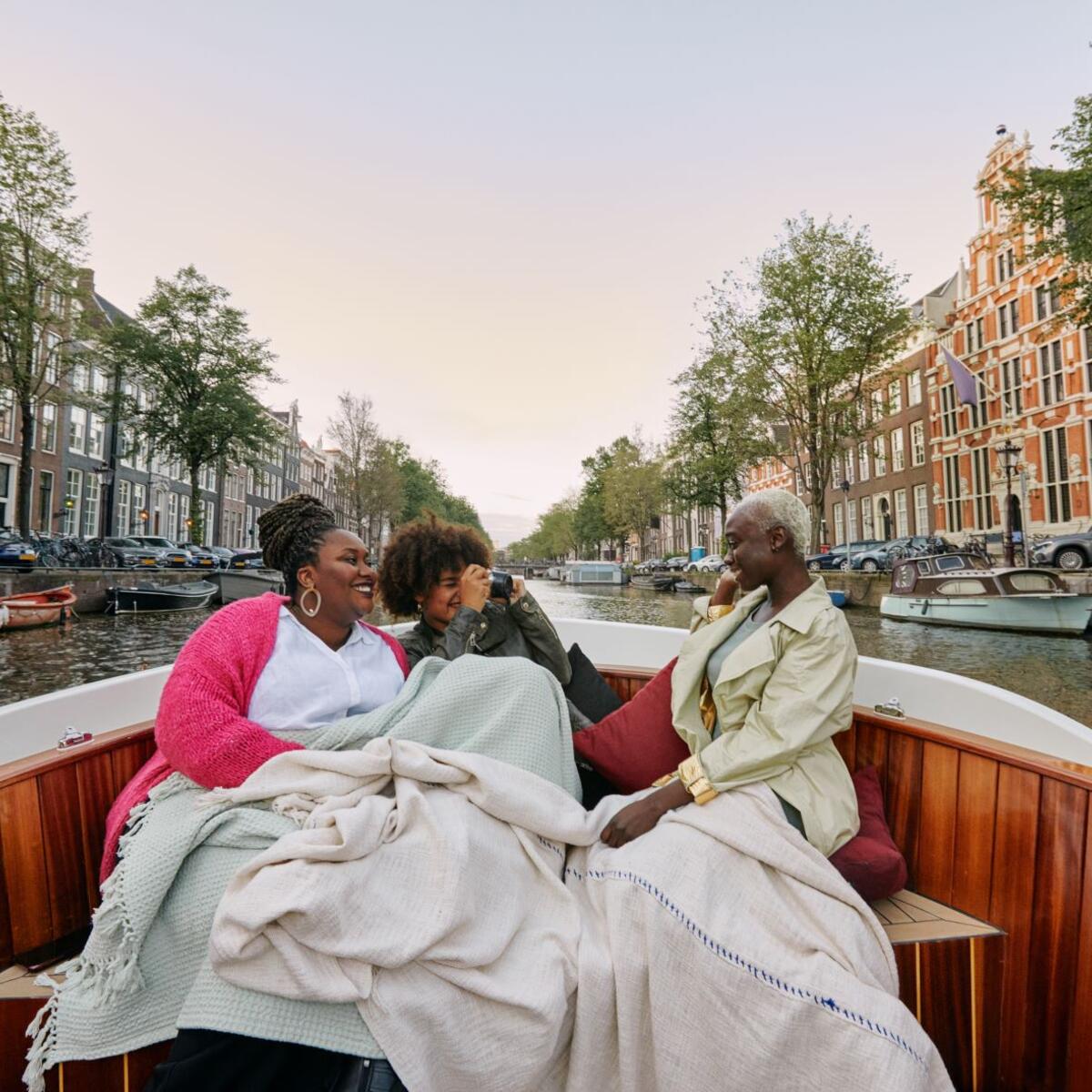 Three women sitting in a boat.