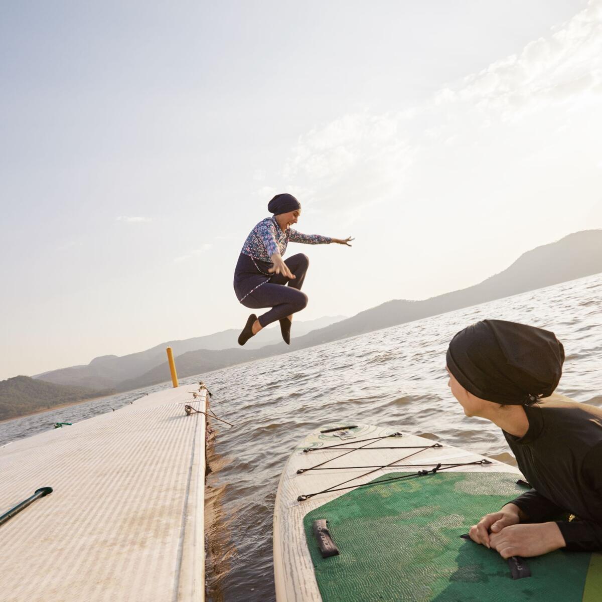 A person jumps into a lake in one of the images available as part of Delta's joint "Faces of Travel" campaign and database.