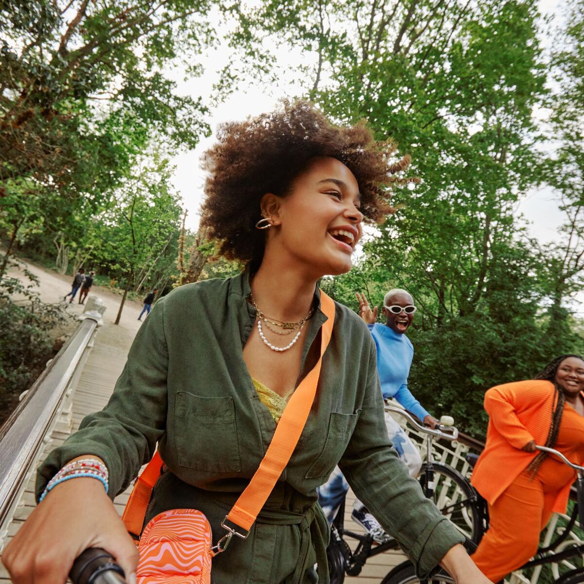Three women bicycling in Vondelpark, Amsterdam