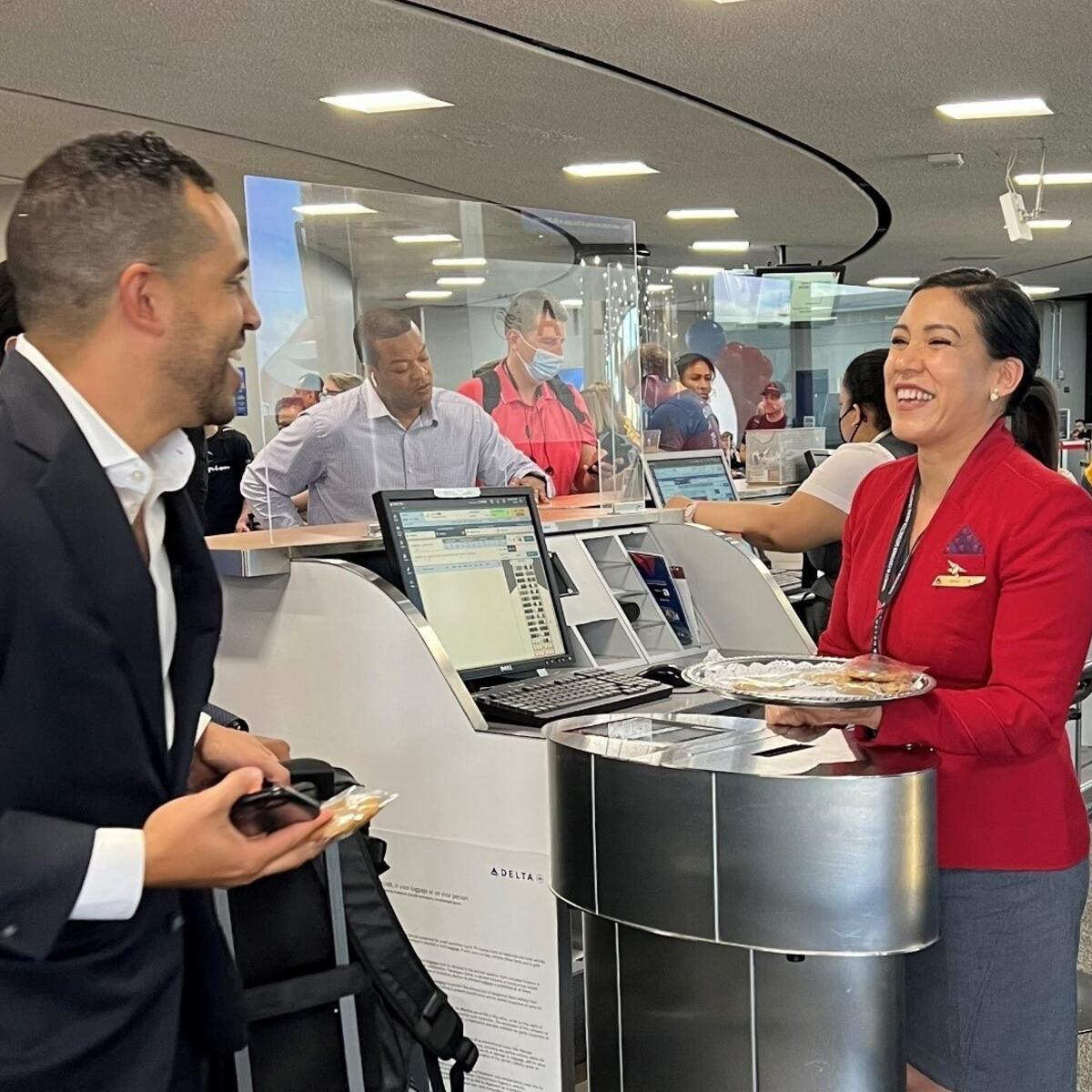 Red Coat Erika Robalino serves a customer. 