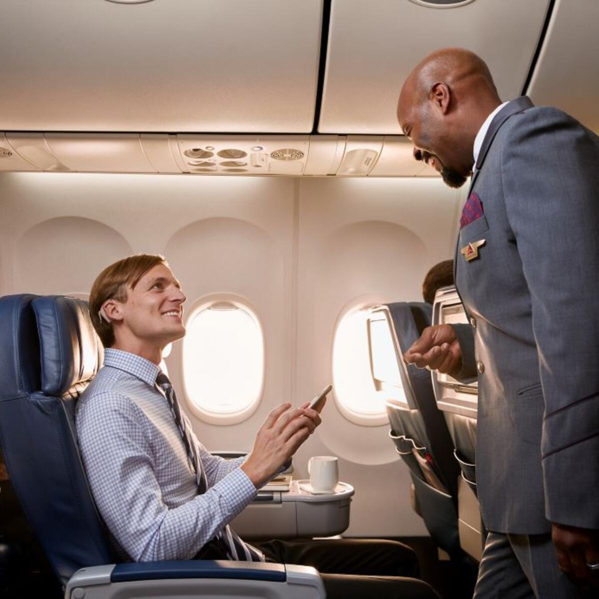Flight attendant helping customer on board