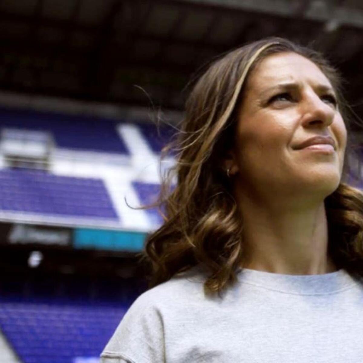 Close up of soccer legend Carli Lloyd standing in a soccer stadium