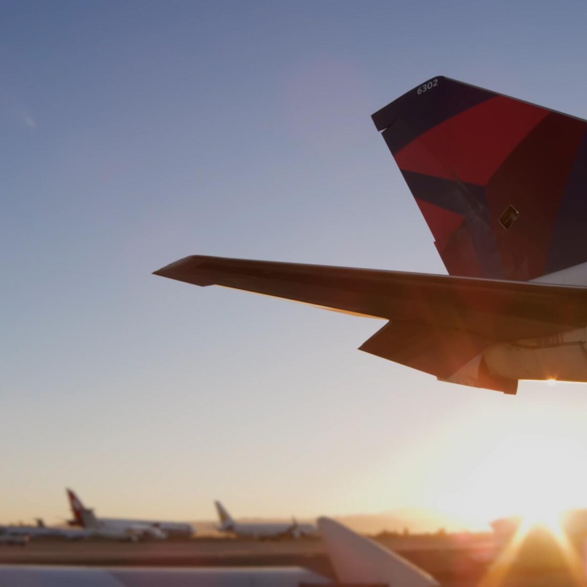 Sun rising behind tail of Boeing 747