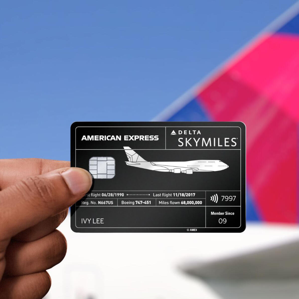 Amex card in hand with plane tail
