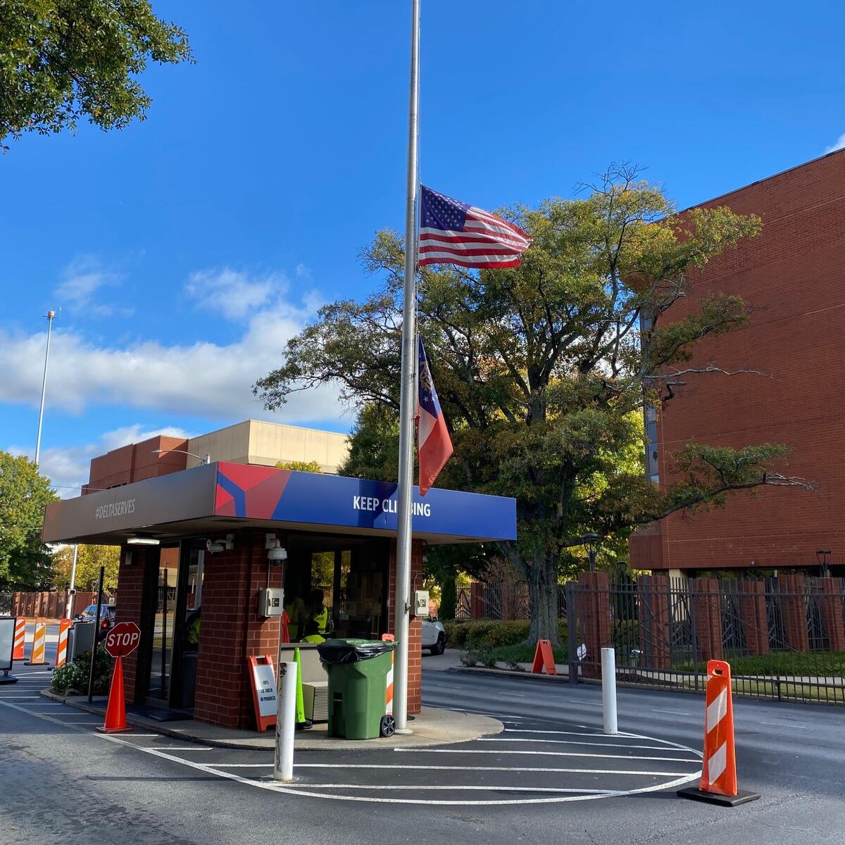 Flags are shown at half-staff at Delta's Atlanta headquarters on Wednesday, Oct. 26, 2022.