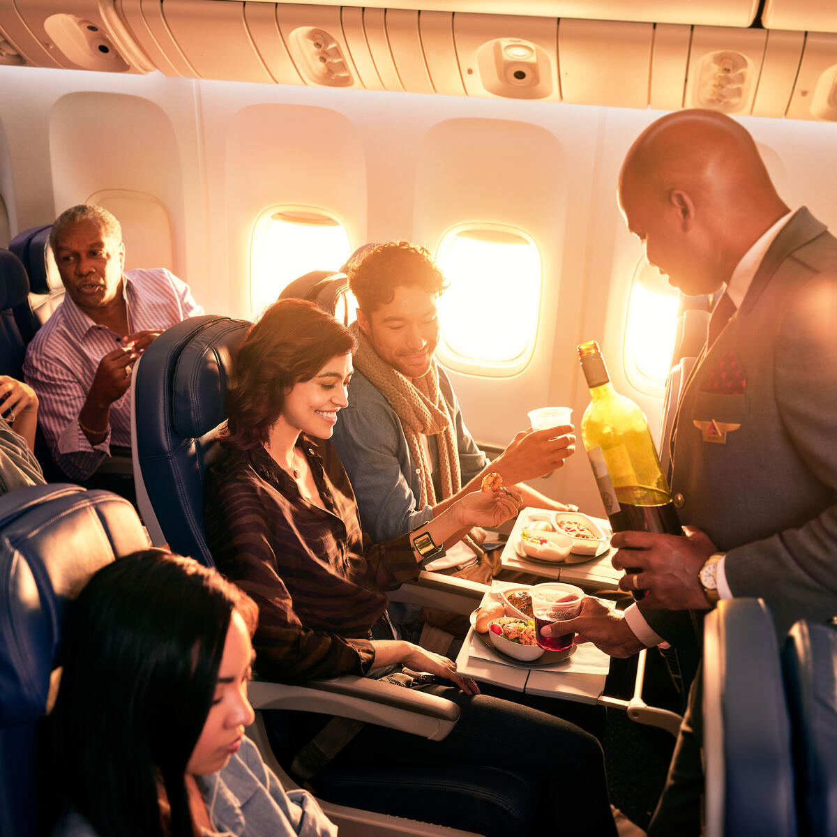 Delta Flight Attendant Robert F. serves customers on board.