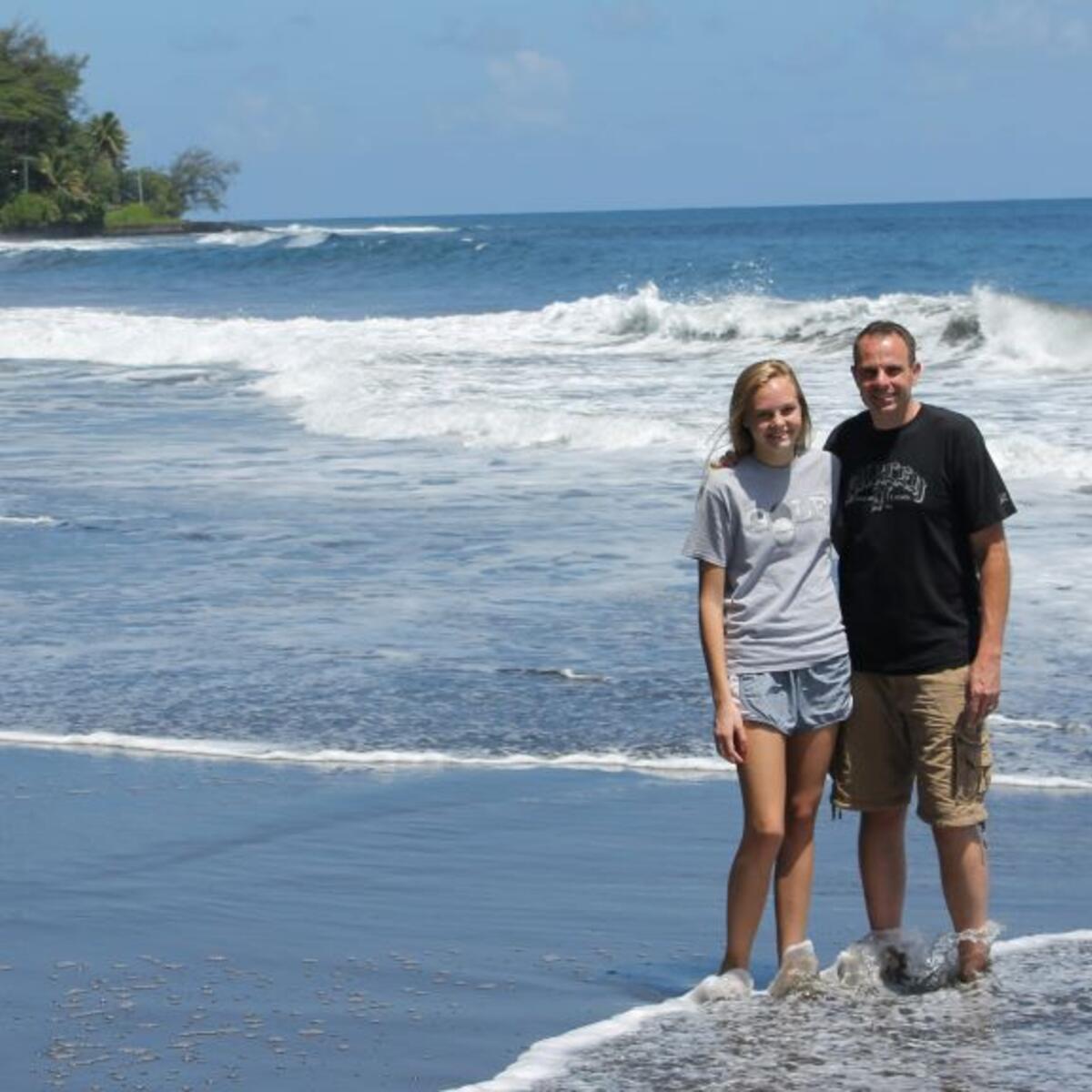 A320 Delta Captain Michael Wilkinson and his daughter stand on a beach in Tahiti.