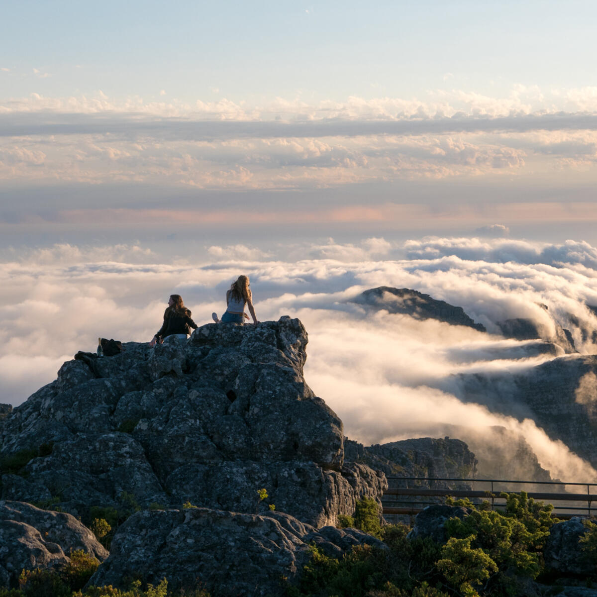 People on Table Mountain against cloudscape in Cape Town, South Africa.
