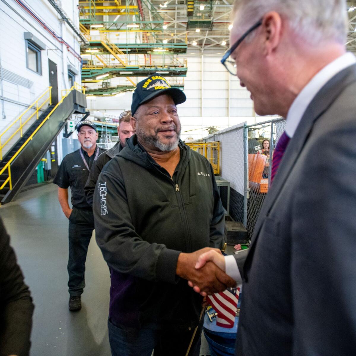 Delta CEO Ed Bastian shakes hands with one of the airline's TechOps employees at an annual Veterans Day celebration on Nov. 4, 2022.