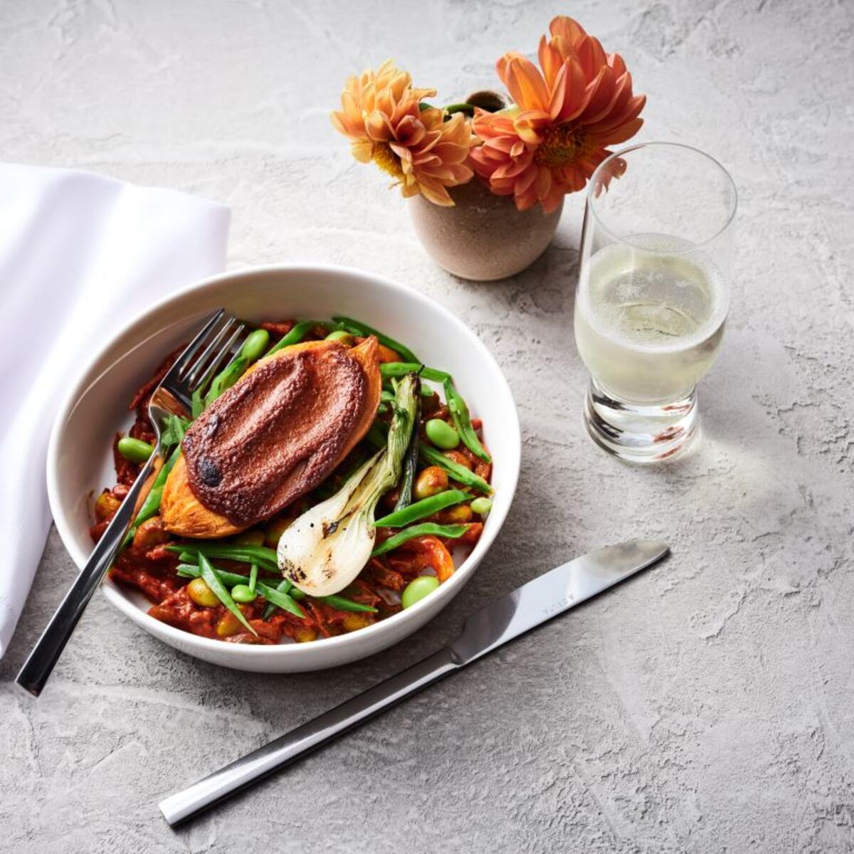 A bowl of roasted sweet potato tagine with chermoula sauce