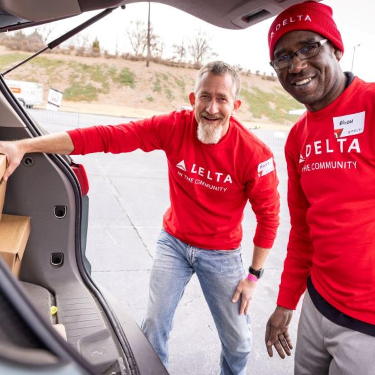 Two Delta employees volunteer at Hosea Helps in Atlanta during the annual "Hosea Helps Festival of Services" event.