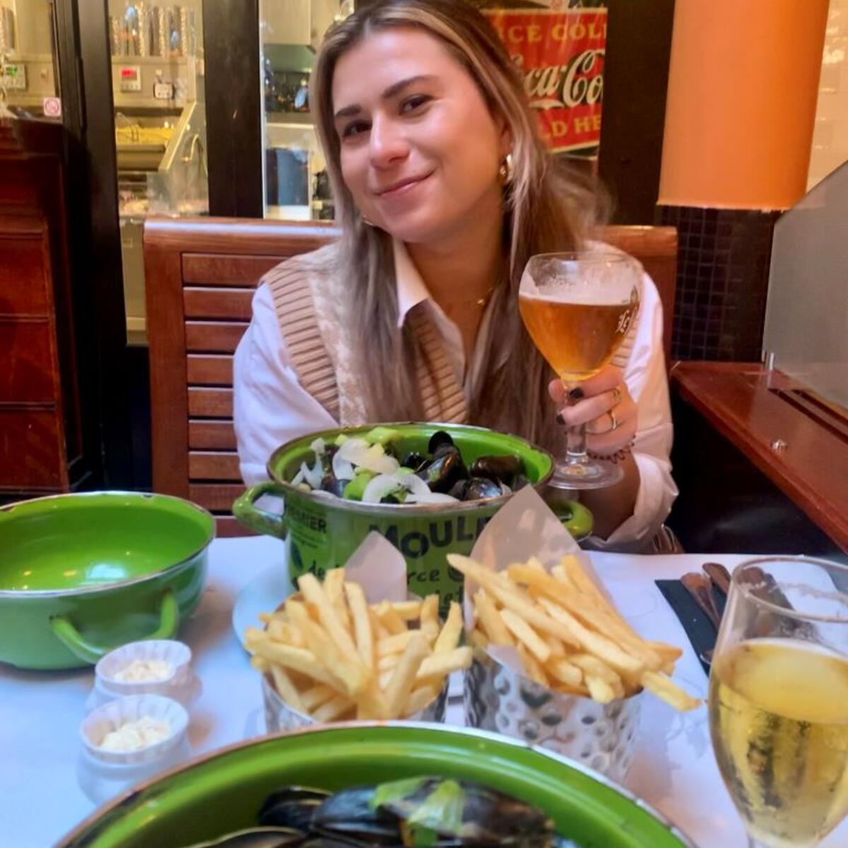 A Delta employee enjoys a meal of moules frites in Brussels