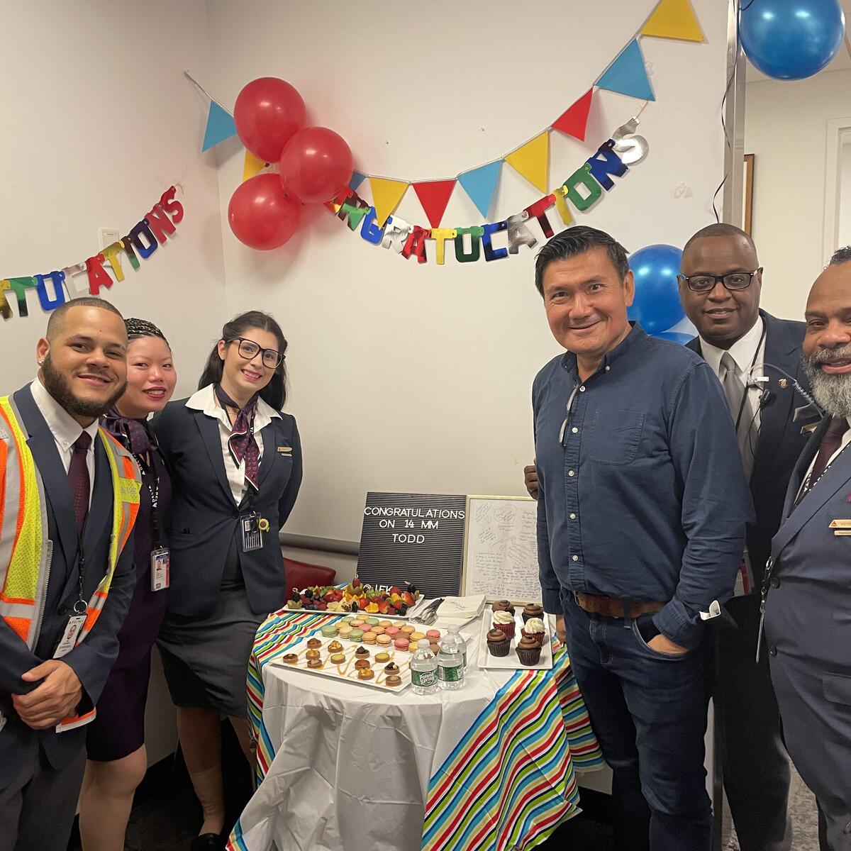 Todd O. celebrates achieving 14 Million Miler Status with Delta people at John F. Kennedy International Airport (JFK).