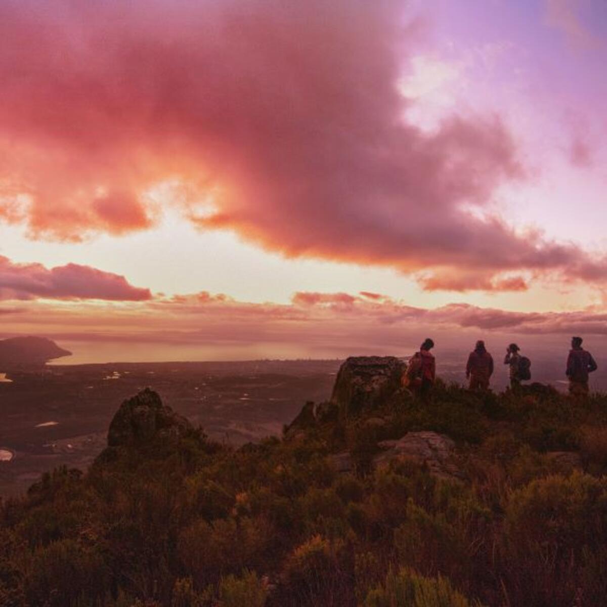 People on a mountaintop with a colorful sunset for Delta's new "Kaleidoscope" brand spot.