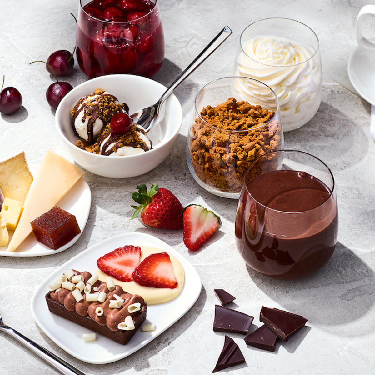 The Delta One dessert carts features a variety of treats like opera cake with chocolate ganache; Cowgirl Creamery wagon wheel, Midnight Moon gouda, and grapes.