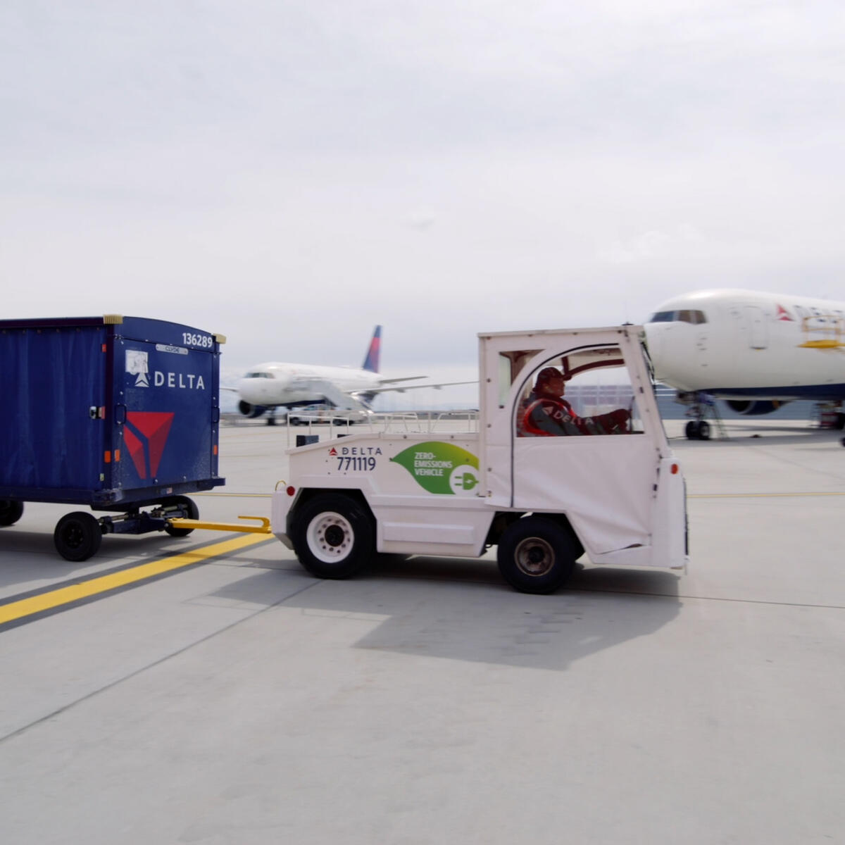 A Delta ramp agent drives an electric bag tractor at Salt Lake City International Airport (SLC).