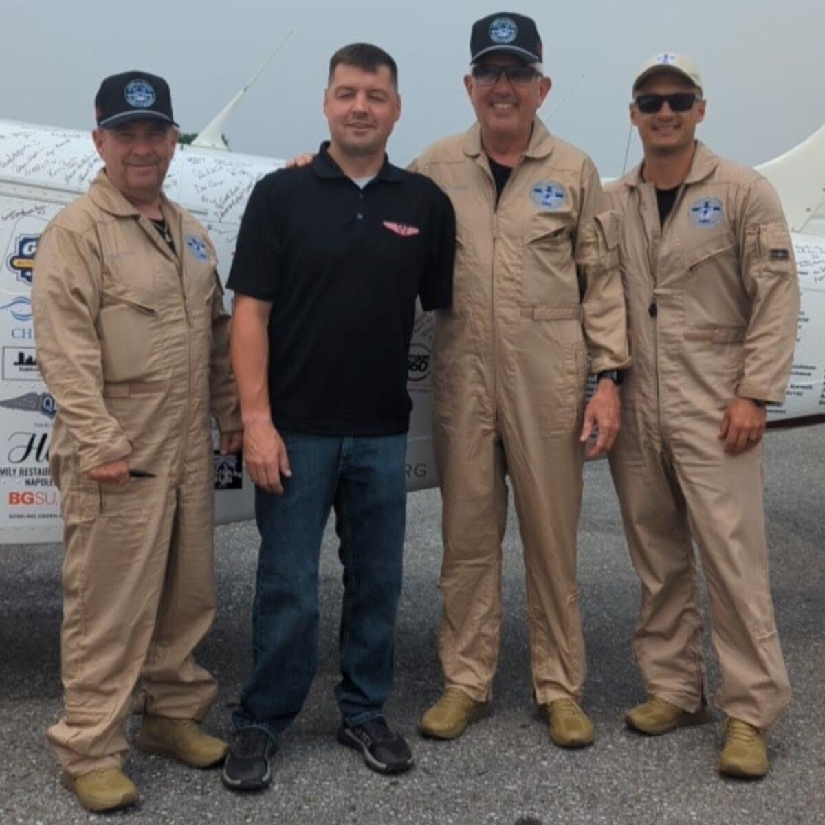 The members of the 48N48 mission pose with Adam Kisielewski, a combat-wounded veteran and member of the Veterans Airlift Command advisory board, during their stop in Maryland.