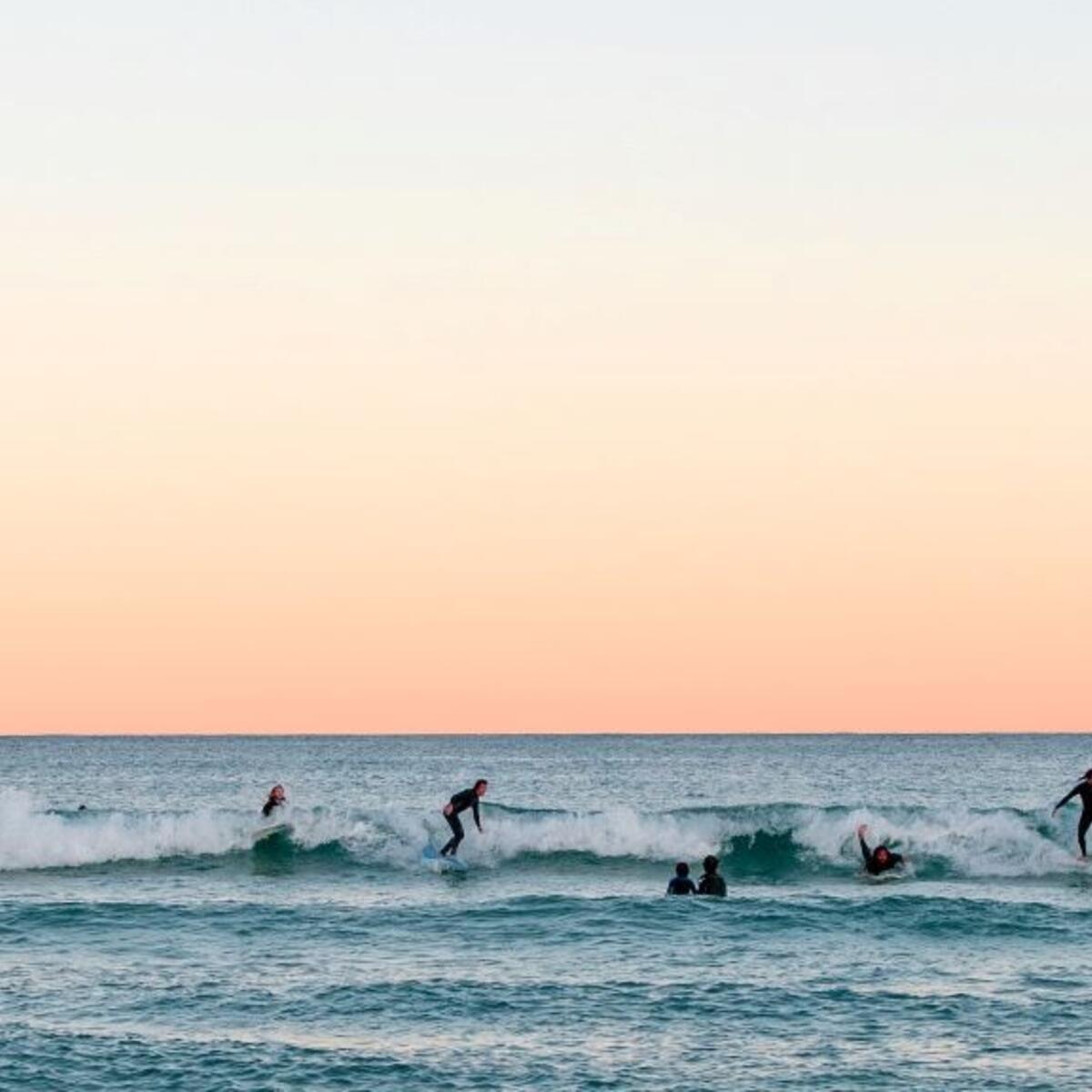Surfers catch waves at Bondi Beach in Sydney, Australia