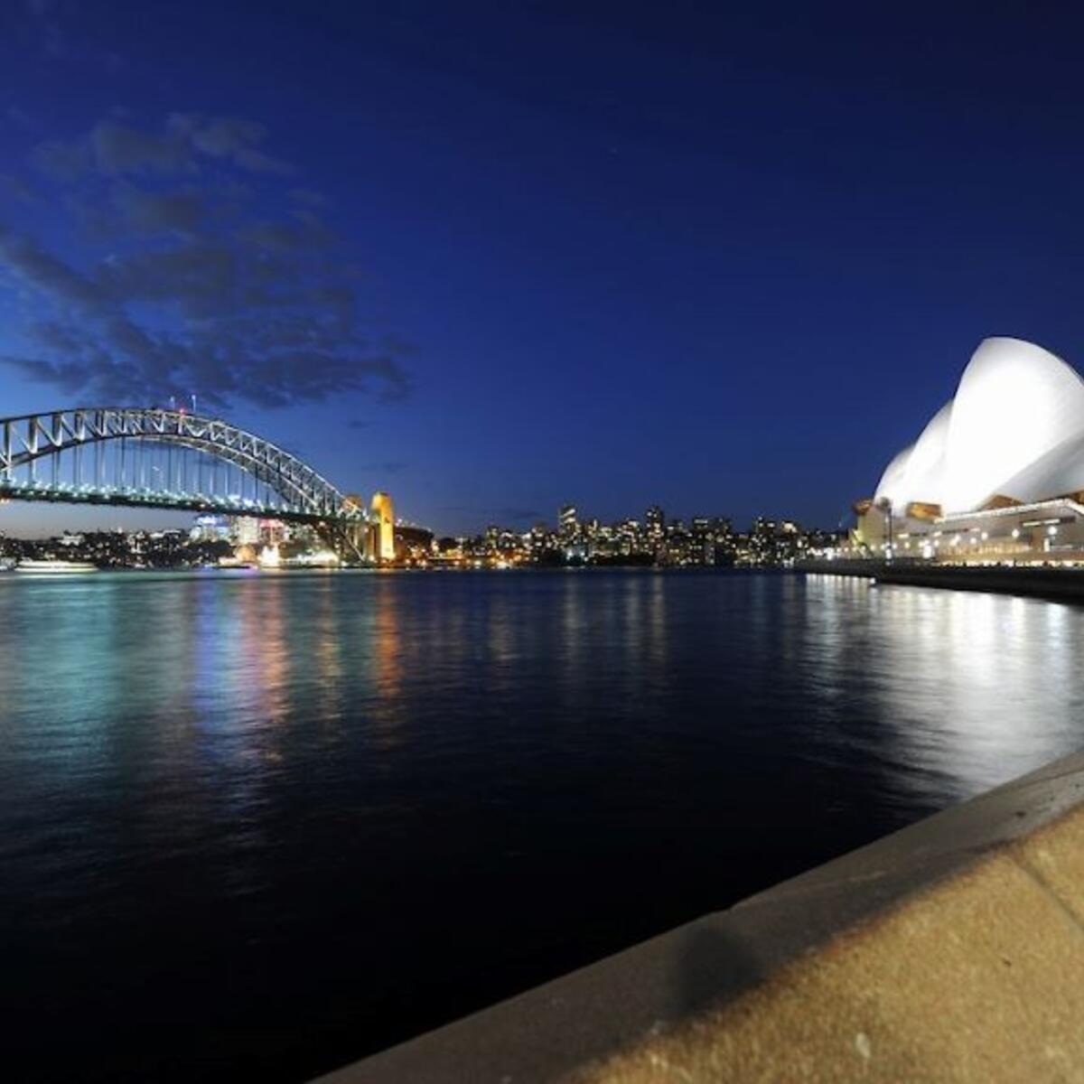 A nightime view of the Sydney Harbour Bridge and Sydney Opera House