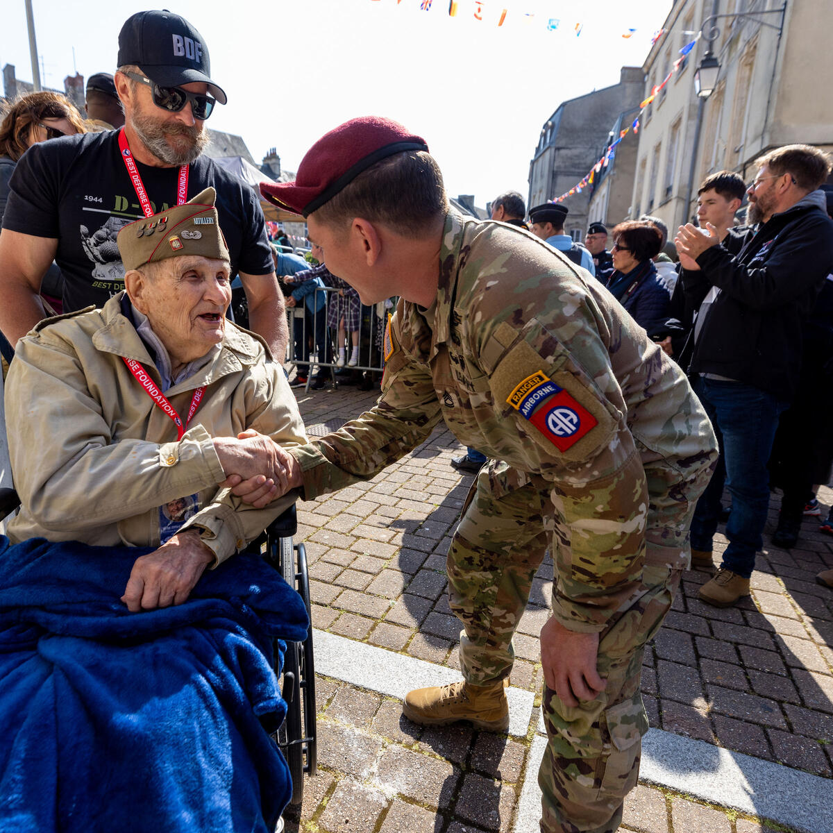 A World War II veteran is greeted by an Army Ranger in Normandy in June 2023.