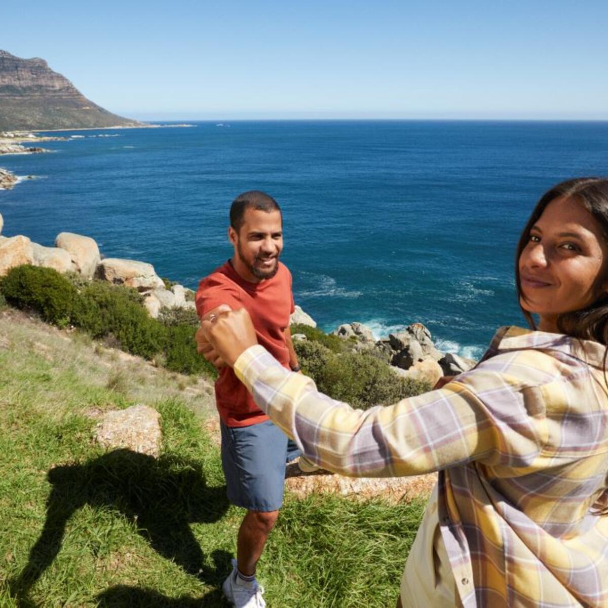 A couple standing in front of Hout Bay in South Africa
